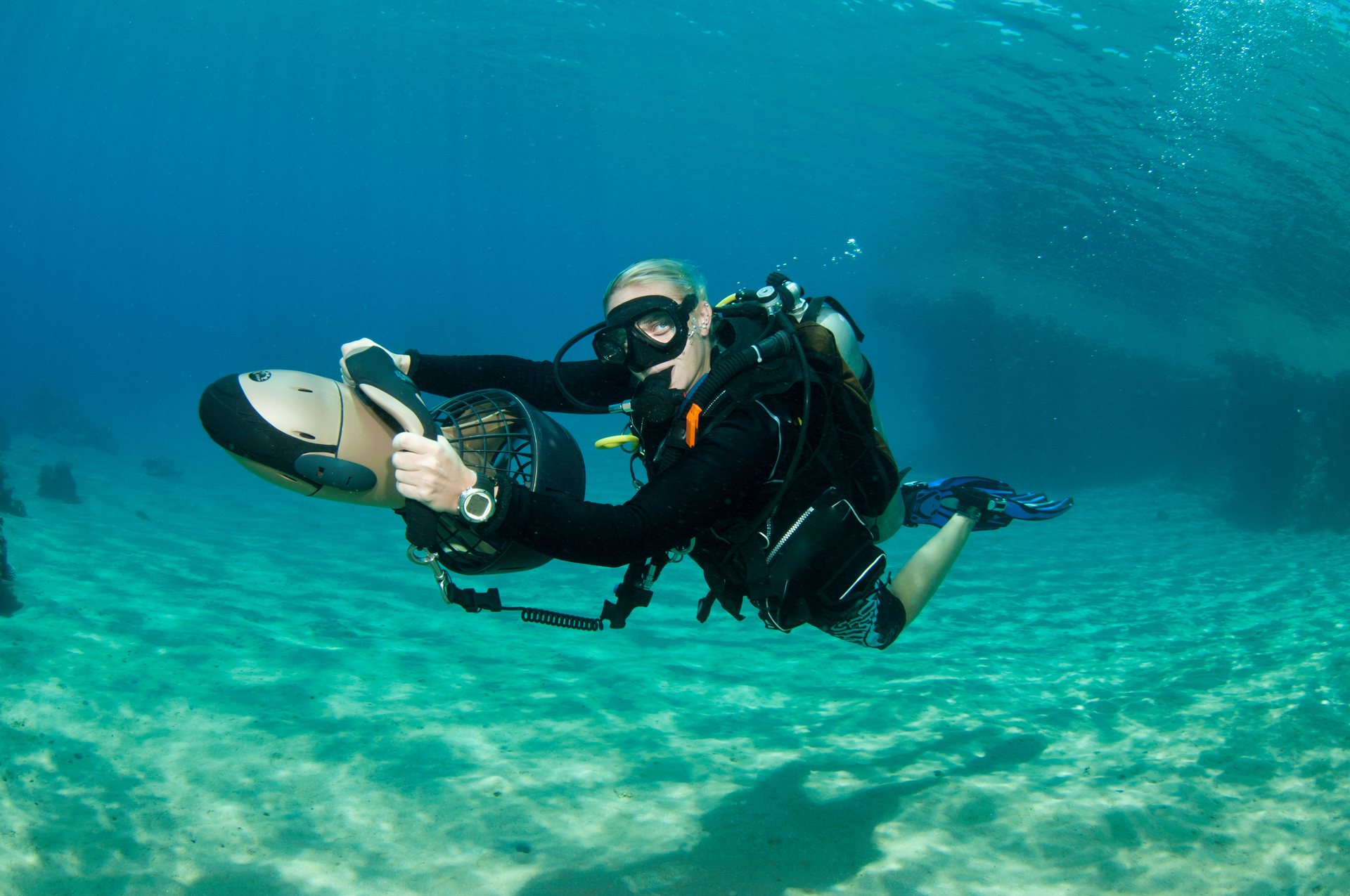 Scuba diver travelling underwater with a diver propulsion vehicle
