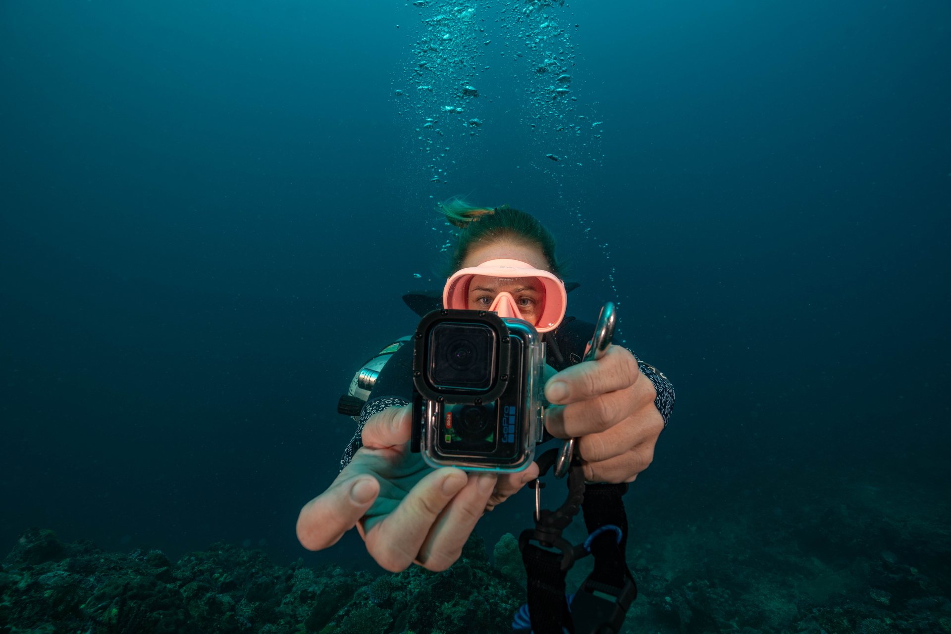 Scuba diver using an underwater camera