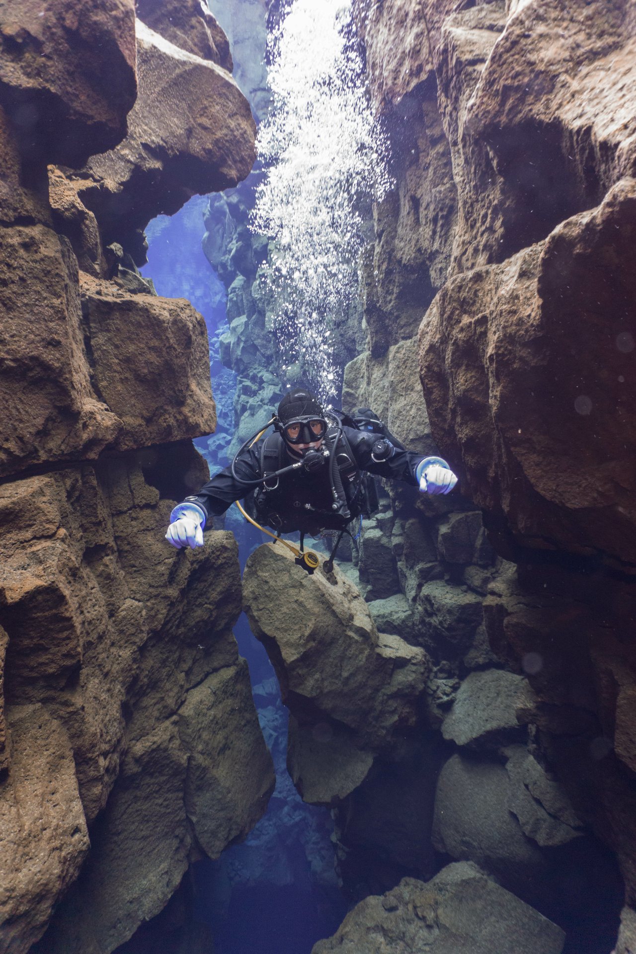 Diver exploring a dramatic underwater rock formation