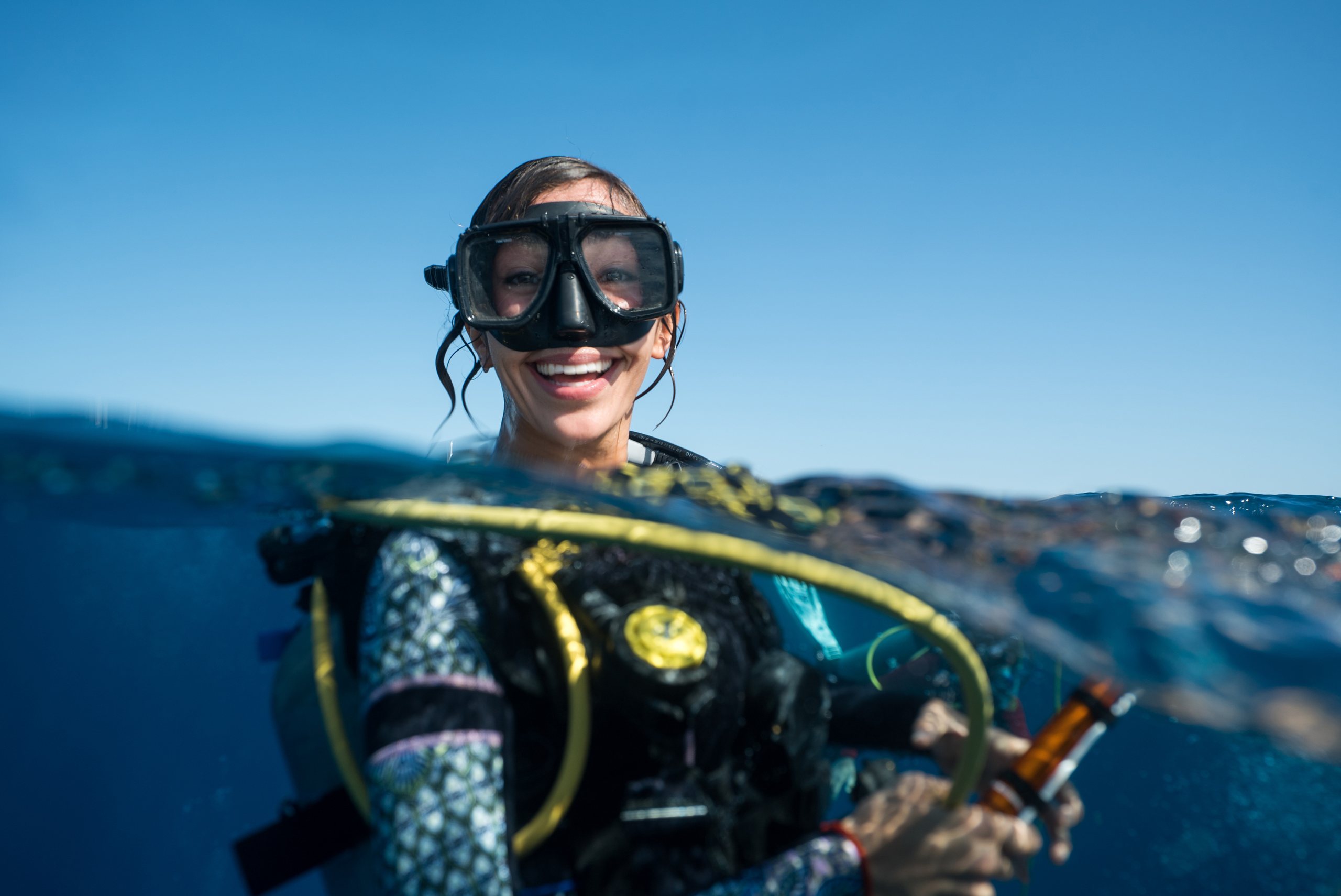 A smiling diver beginning her underwater adventure