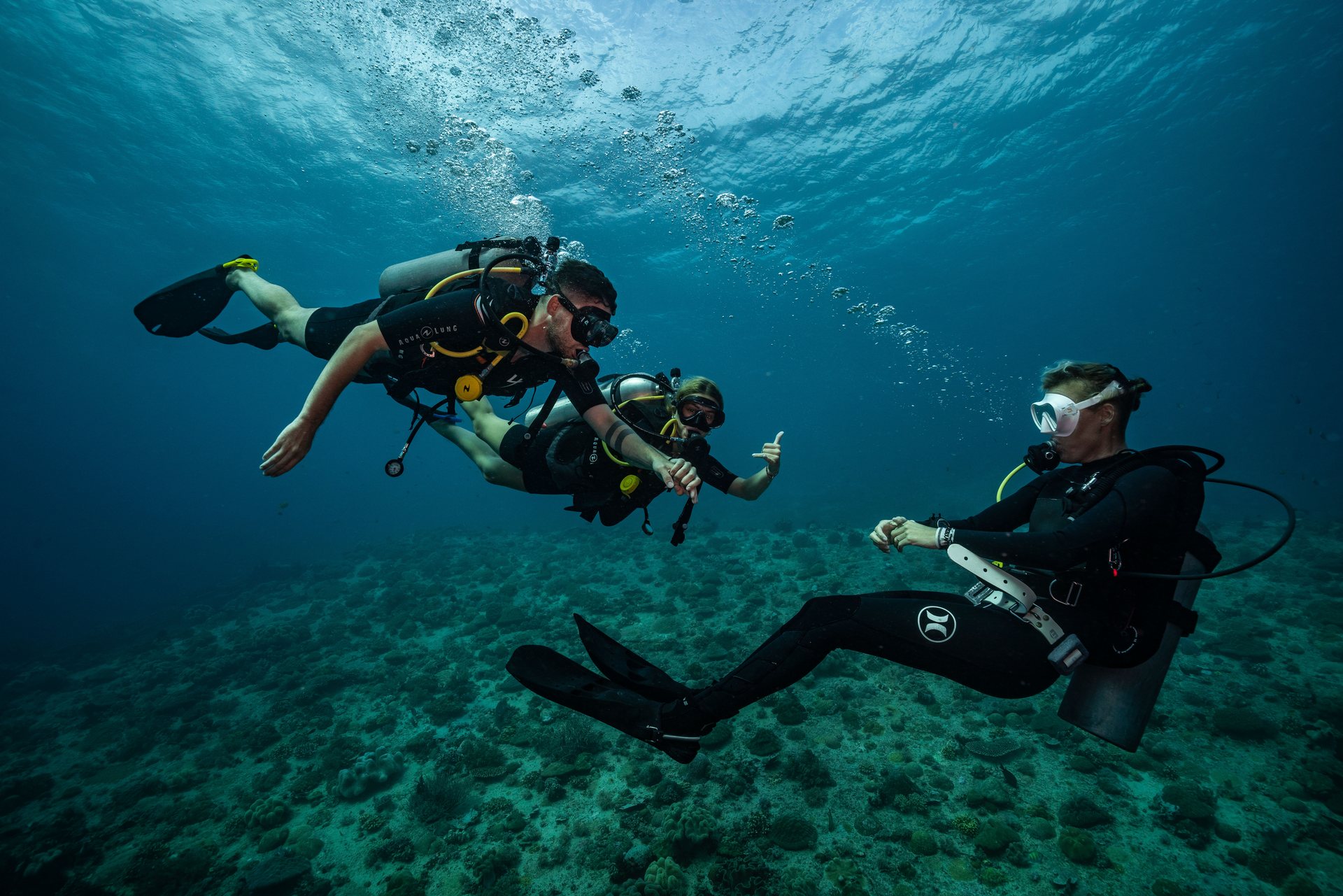 Student divers training underwater with a scuba instructor
